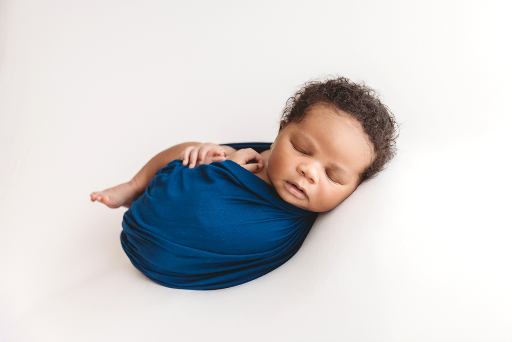 Close-up of newborn Braylen peacefully sleeping on a small pillow
