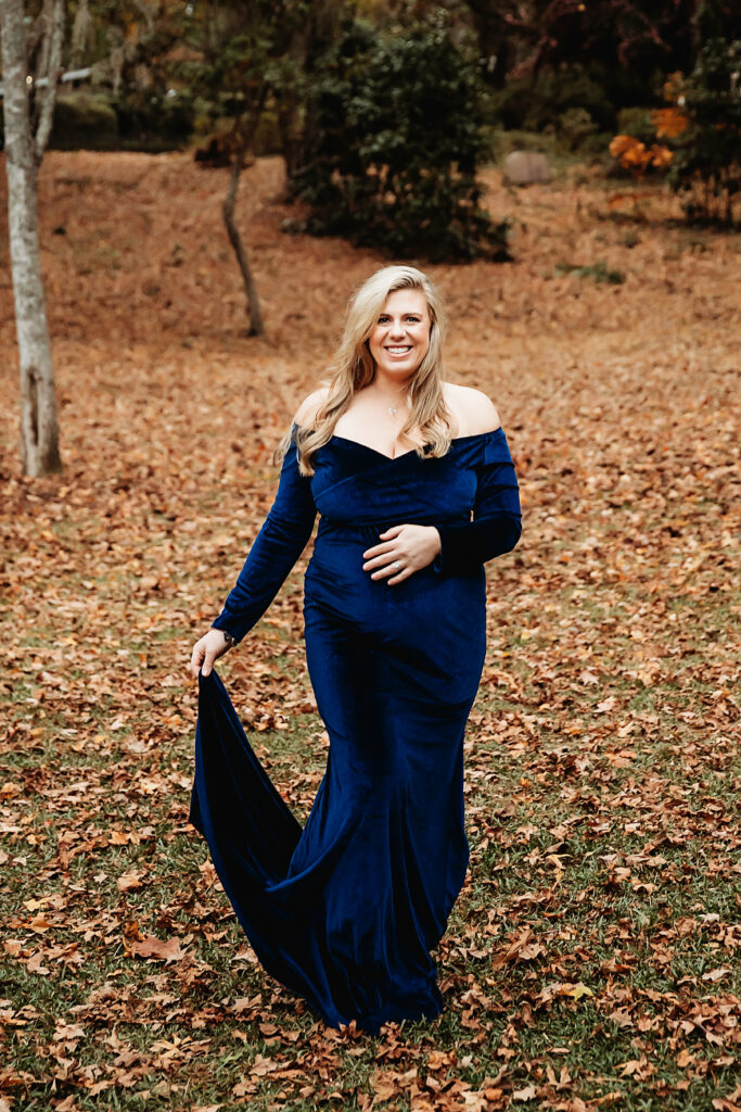 Maternity portrait with confident look and flowing blue dress