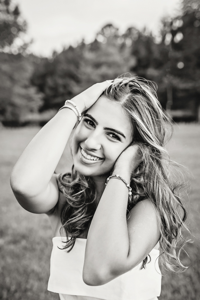 Senior session photo taken in black and white hands in hair