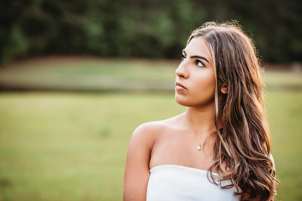 golden hour at golden hour, showing a looking-away pose in floral dress from a full-body angle at Reflection Images by Tracy Rowell in Florence SC.