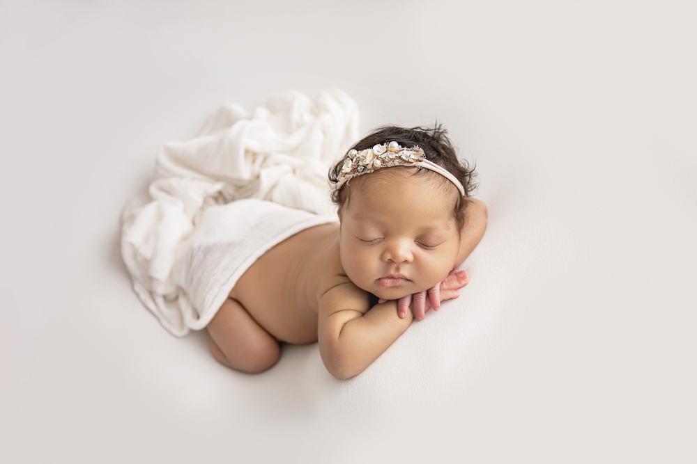 african american newborn baby posed in white
