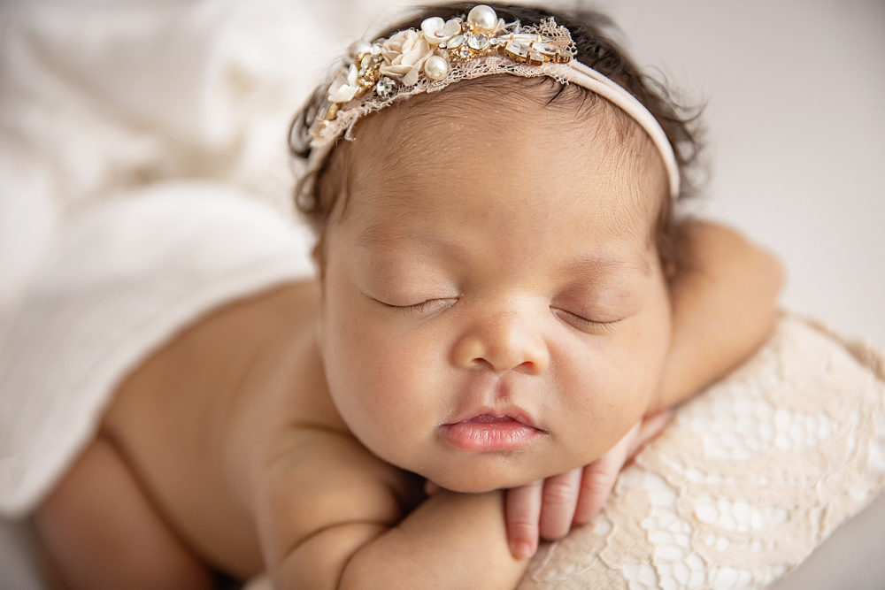 african american newborn baby chin on hands pose