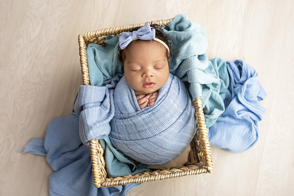 newborn wrapped baby blue basket