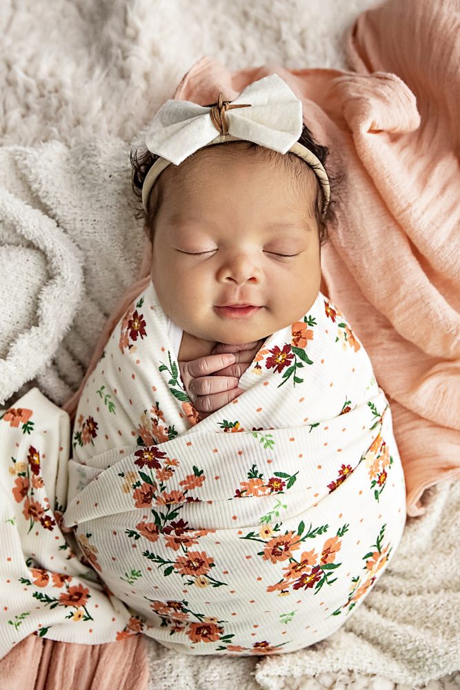 Newborn floral wrap baby smiling image