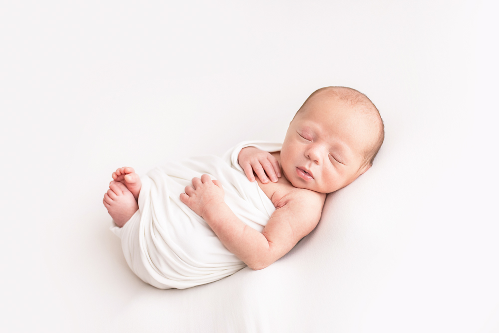 full-body newborn Walker loosely swaddled in white on white beanbag Florence SC