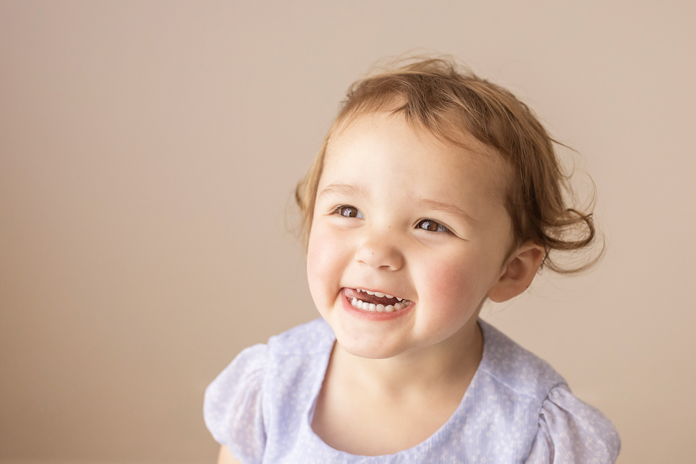 big sister laughing in lavender dress studio portrait Florence SC
