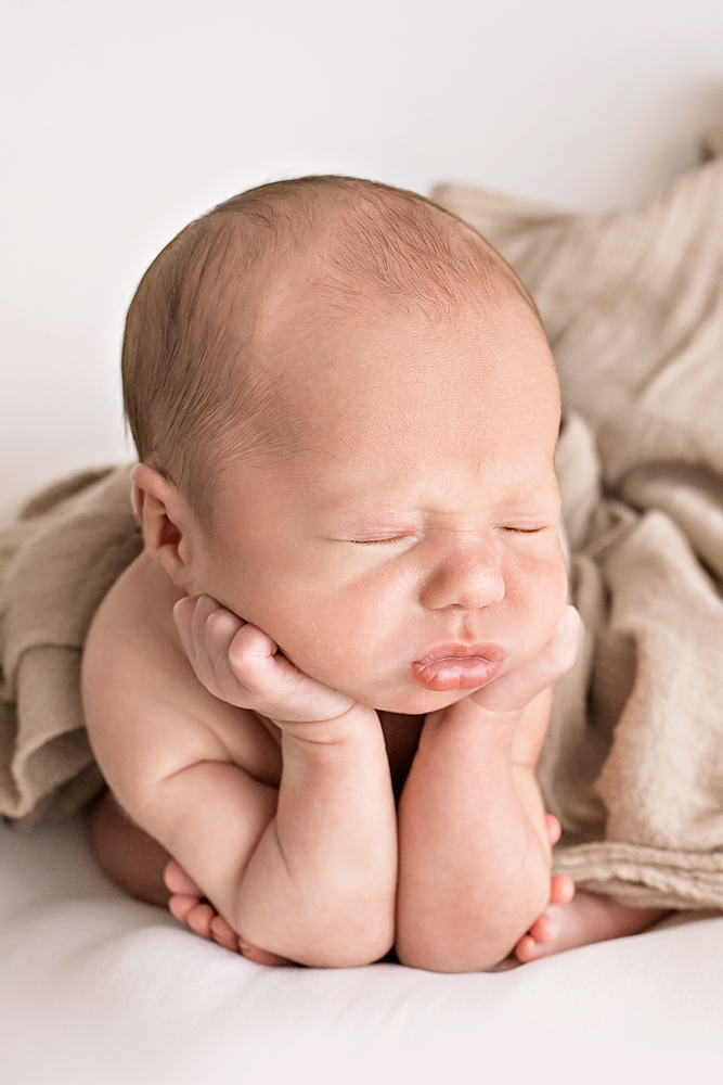 Reflection Images by Tracy Rowell professional photography froggy pose close-up newborn supported on tan blanket soft light Florence SC