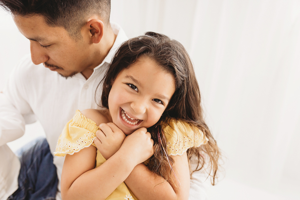 Buenrostro dad daughter close laugh in warm, joyful feel with candid connection at Reflection Images by Tracy Rowell in Florence SC