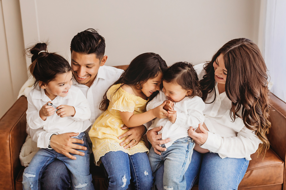 Buenrostro family group hug on bench in warm, joyful feel with candid connection at Reflection Images by Tracy Rowell in Florence SC