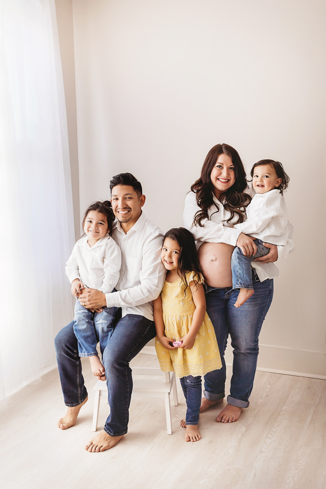 Buenrostro family standing group moms belly in warm, joyful feel at Reflection Images by Tracy Rowell in Florence SC
