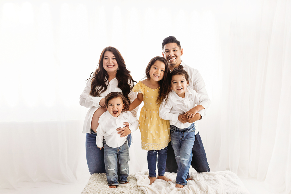Buenrostro full family portrait studio in bright natural light and clean studio backdrop at Reflection Images by Tracy Rowell in Florence SC