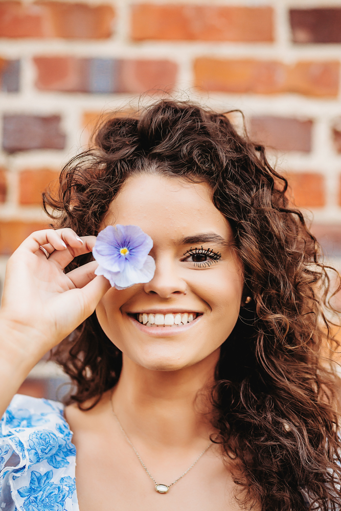 fun close-up of hayden with a purple flower photography session reflection images in Georgetown SC