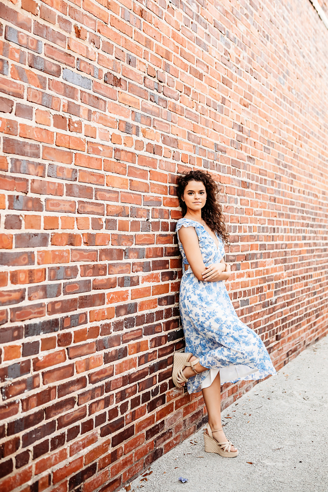 reflection images hayden leaning against rustic brick wall downtown Georgetown SC birthday session