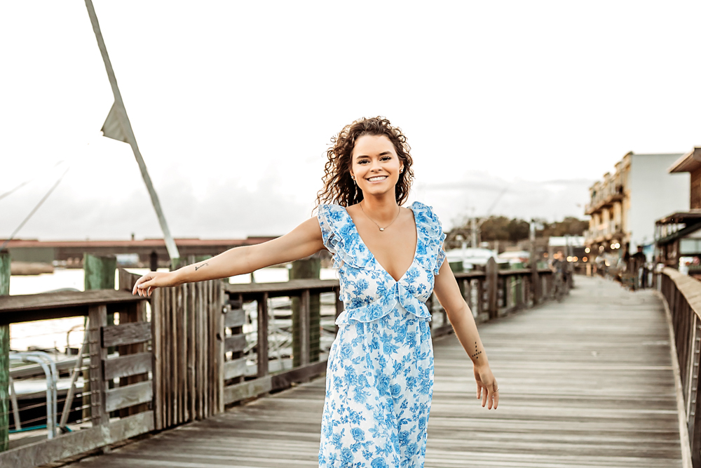 hayden leaning forward laughing by dock railing Georgetown SC