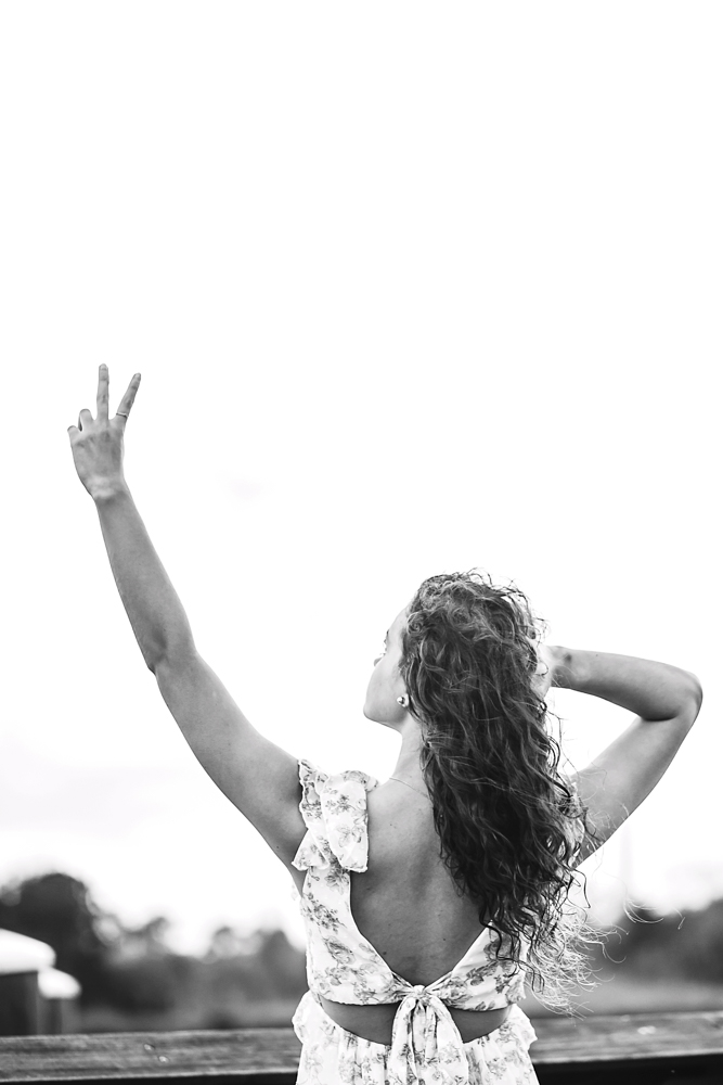 black and white back view of hayden raising arms in peace and zero gesture for 20th birthday Georgetown SC