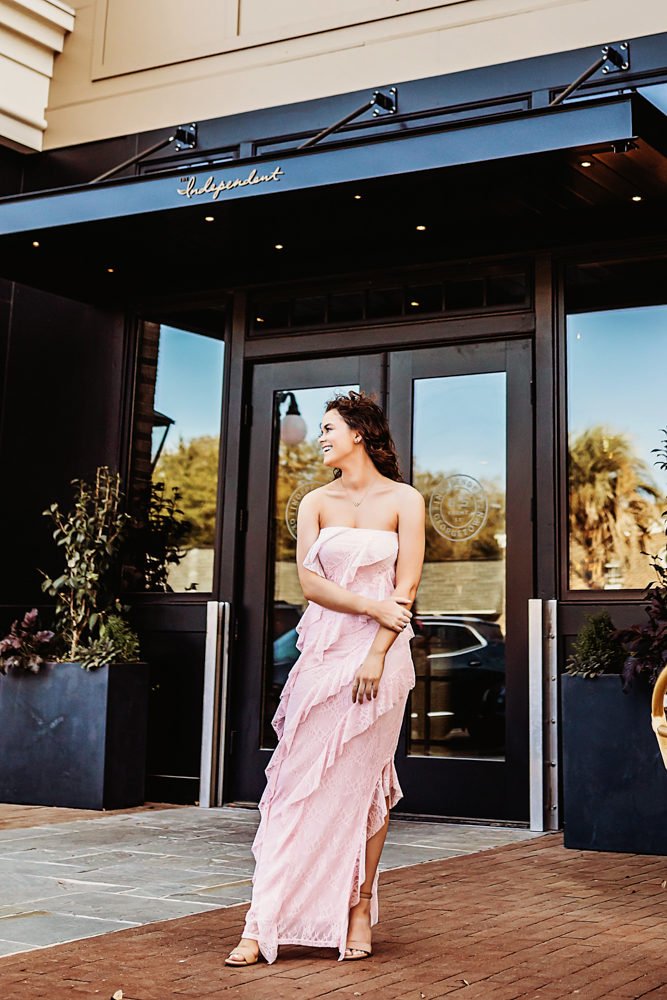 hayden in pink dress in front of restaurant doors downtown georgetown sc