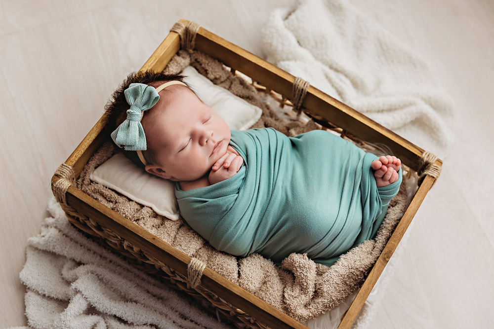 Baby Logan wrapped in basket at Reflection Images by Tracy Rowell in Florence SC