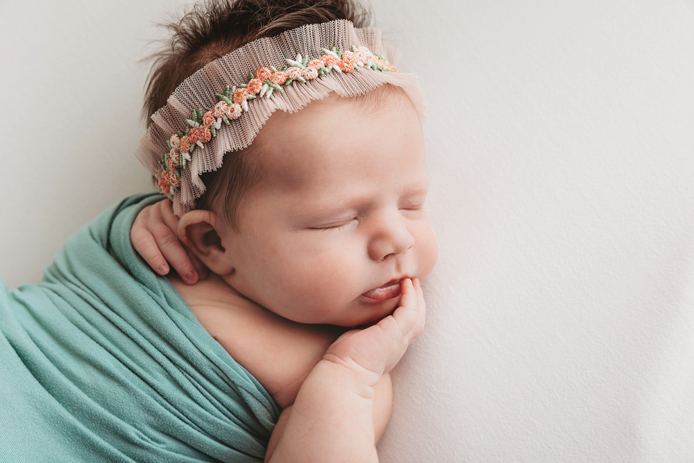 Baby Logan wrapped in green at Reflection Images by Tracy Rowell in Florence SC