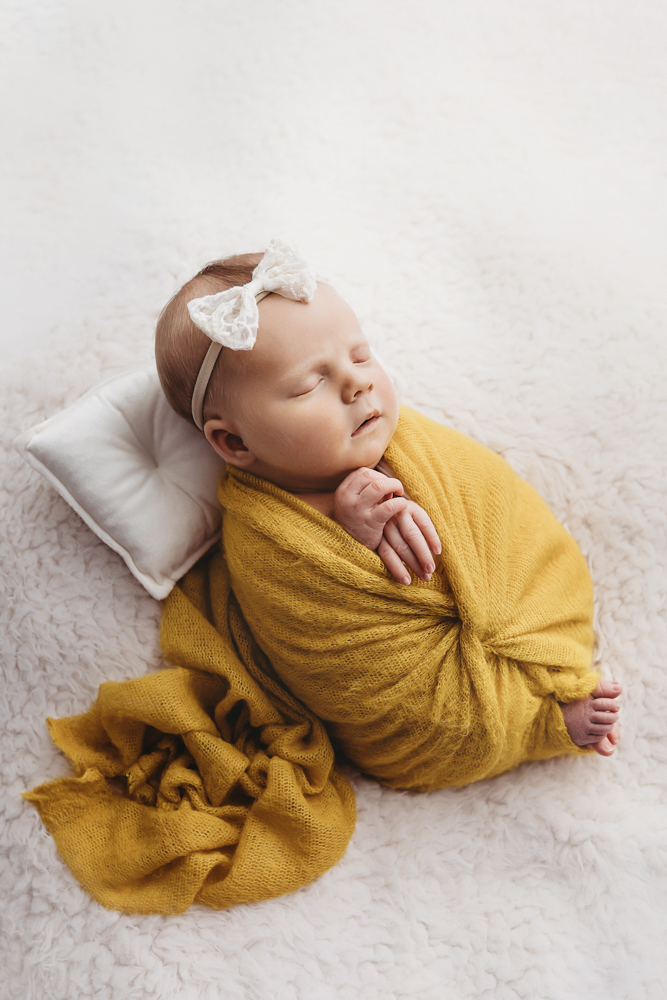 gina_newborn_photographer_south_carolina (7 of 19).jpg newborn-mustard-wrap-side-florence-sc-07 Side pose of Millie Jo wrapped in mustard with tiny feet peeking out at Reflection Images by Tracy Rowell in Florence SC