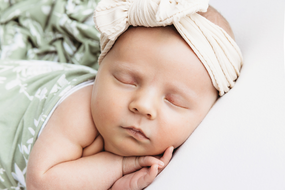 Close-up of Millie Jo face in sage wrap and bow headband at Reflection Images by Tracy Rowell in Florence SC