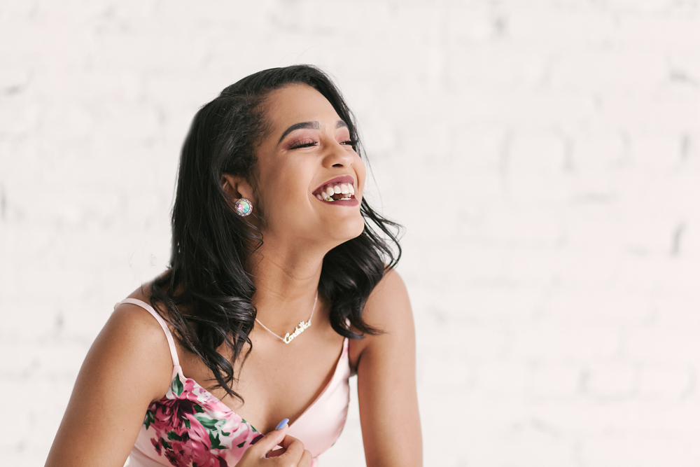 Candid moment of Connie laughing joyfully in a close-up that highlights her 'Connie' necklace and soft curls at Reflection Images by Tracy Rowell in Florence SC