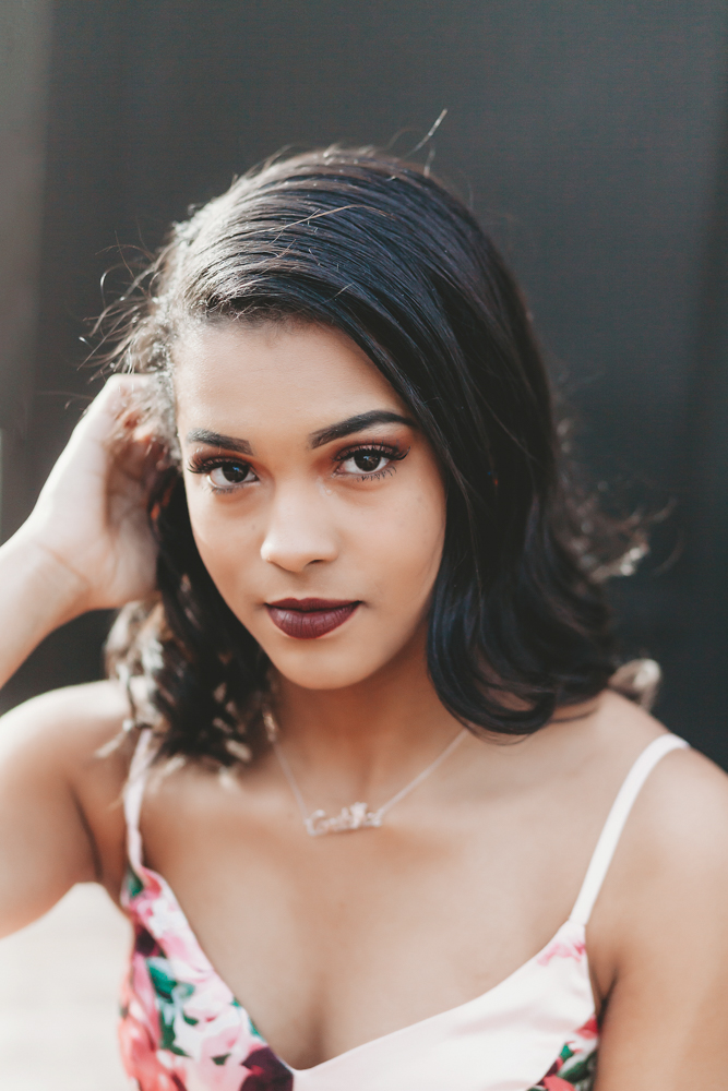 Close-up of Connie with sleek hair and intense eye contact in front of a deep black backdrop outdoors at Reflection Images by Tracy Rowell in Florence SC