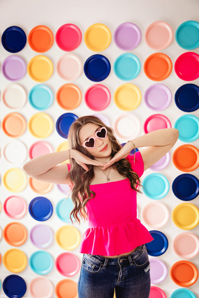 Full-body shot of teen girl in heart sunglasses posing confidently.