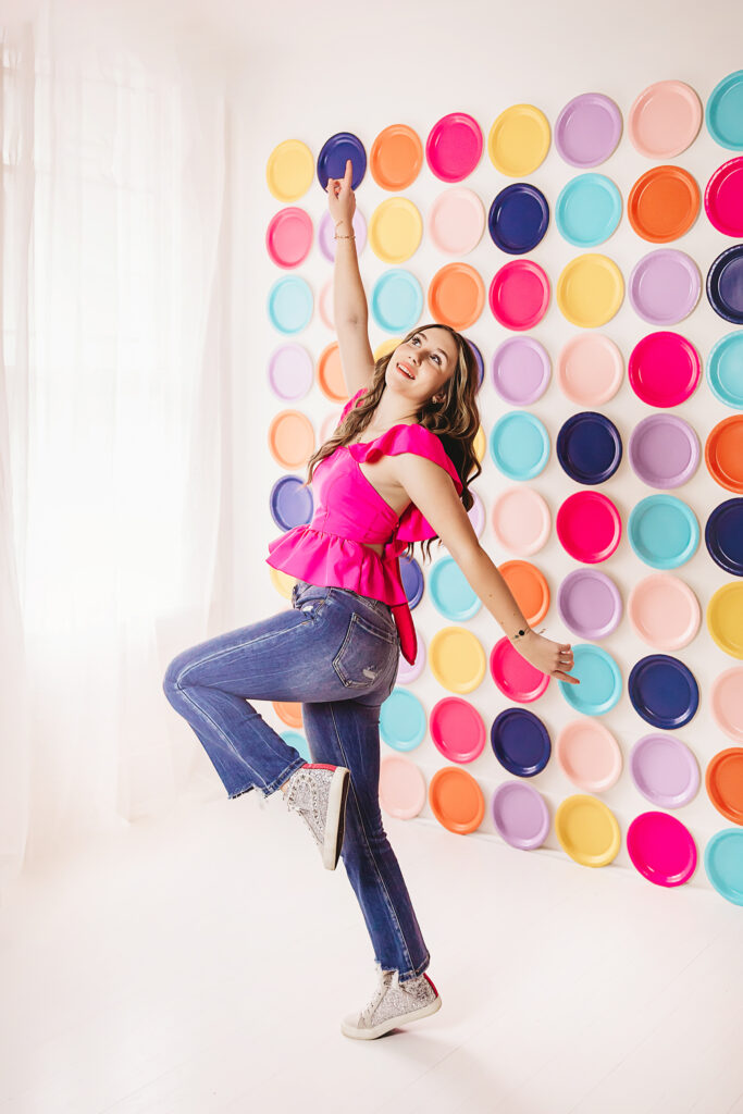 Joyful pointing pose upwards with light streaming in, vibrant and playful atmosphere