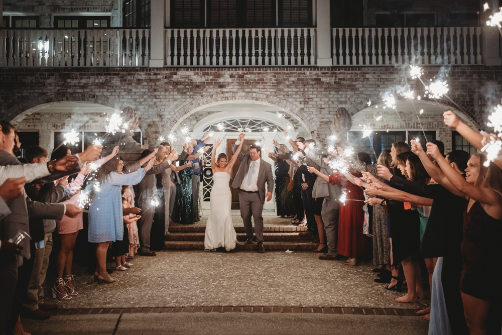 Couple running through sparkling exit with cheering guests at Reflection Images by Tracy Rowell in Florence SC
