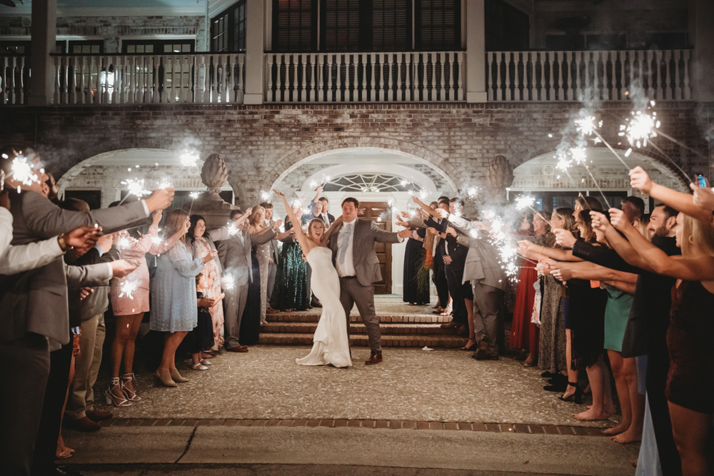 Couple running through sparkling exit with cheering guests at Reflection Images by Tracy Rowell in Florence SC