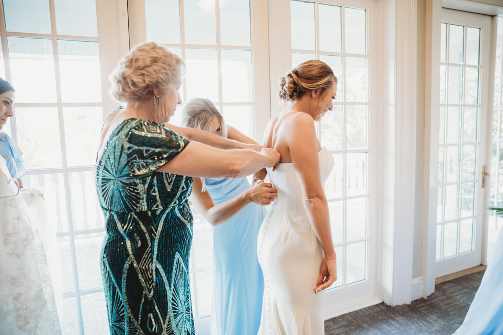 Bridal party group photo with fashionable gowns and suits at Reflection Images by Tracy Rowell in Florence SC