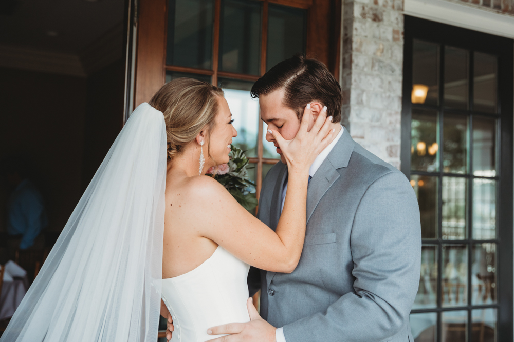 Bride and groom sharing emotional first look before ceremony at Reflection Images by Tracy Rowell in Florence SC