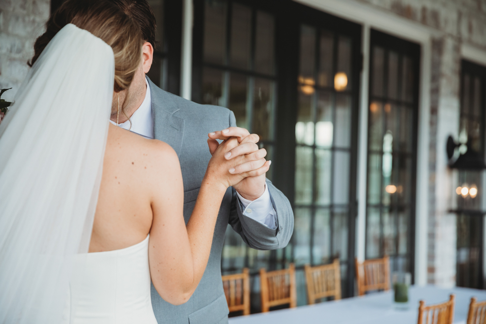 Bride and groom sharing emotional first look before ceremony at Reflection Images by Tracy Rowell in Florence SC