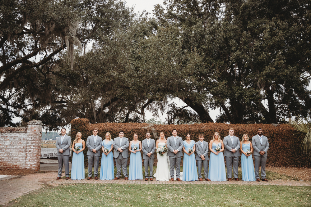 Bridal party group photo with fashionable gowns and suits at Reflection Images by Tracy Rowell in Florence SC