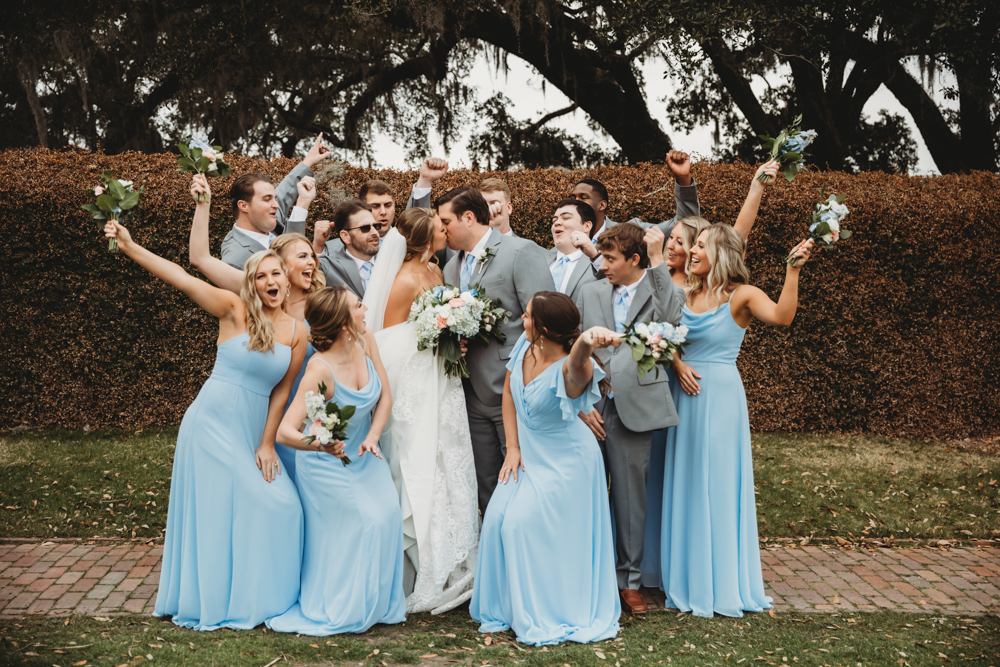 Bridal party group photo with fashionable gowns and suits at Reflection Images by Tracy Rowell in Florence SC