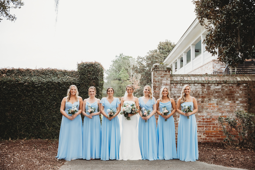 Bridal party group photo with fashionable gowns and suits at Reflection Images by Tracy Rowell in Florence SC