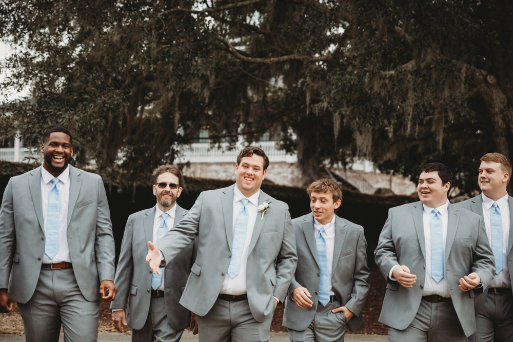 Groomsmen group portrait in coordinated suits with camaraderie at Reflection Images by Tracy Rowell in Florence SC