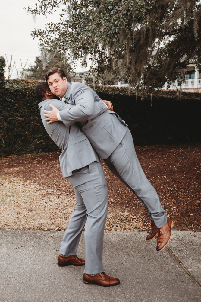 Groomsmen group portrait in coordinated suits with camaraderie at Reflection Images by Tracy Rowell in Florence SC