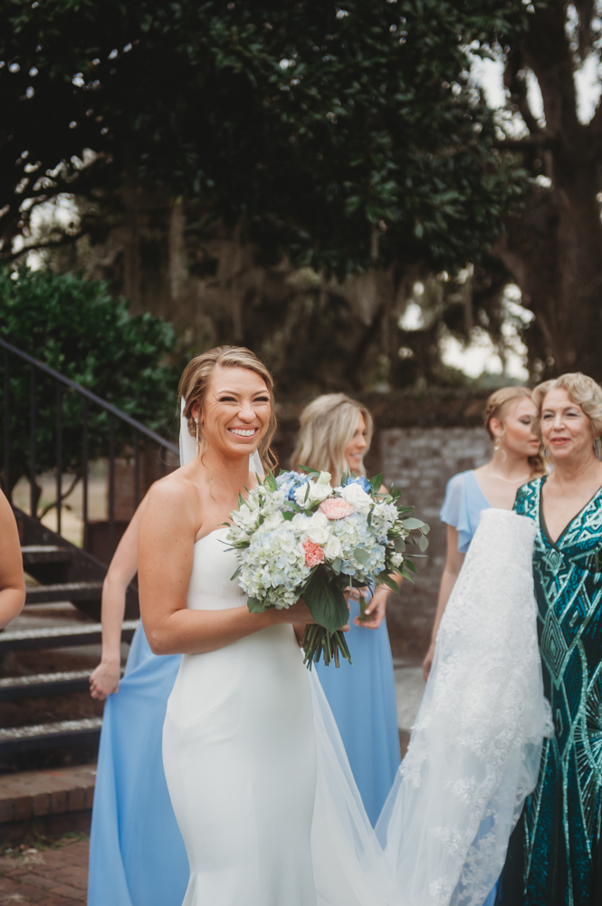 Bridal party group photo with fashionable gowns and suits at Reflection Images by Tracy Rowell in Florence SC