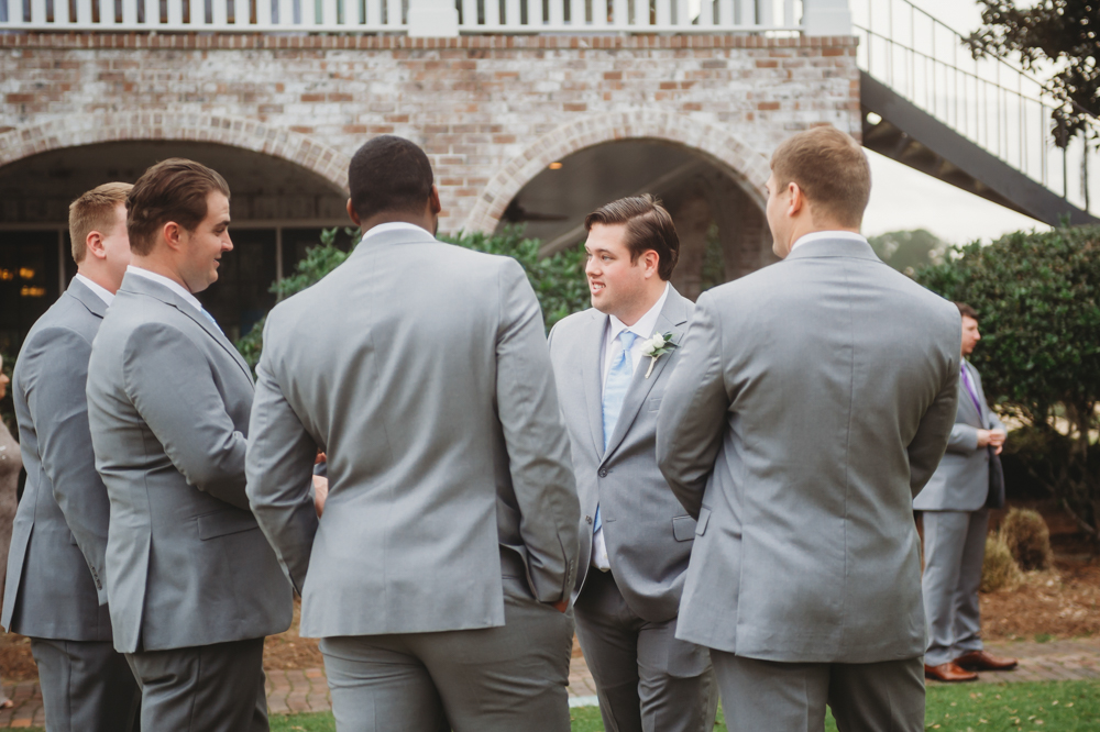 Groomsmen group portrait in coordinated suits with camaraderie at Reflection Images by Tracy Rowell in Florence SC