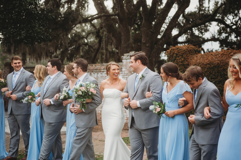 Bridal party group photo with fashionable gowns and suits at Reflection Images by Tracy Rowell in Florence SC