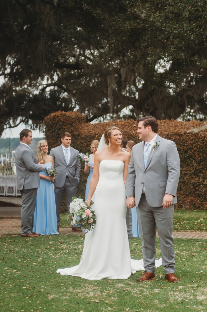 Bridal party group photo with fashionable gowns and suits at Reflection Images by Tracy Rowell in Florence SC