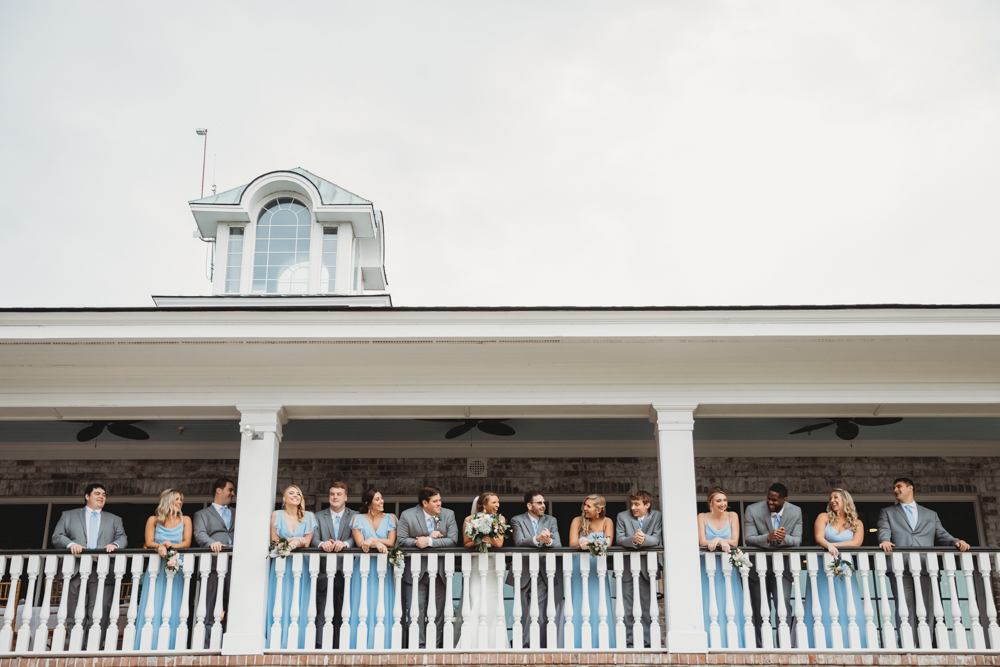Bridal party group photo with fashionable gowns and suits at Reflection Images by Tracy Rowell in Florence SC