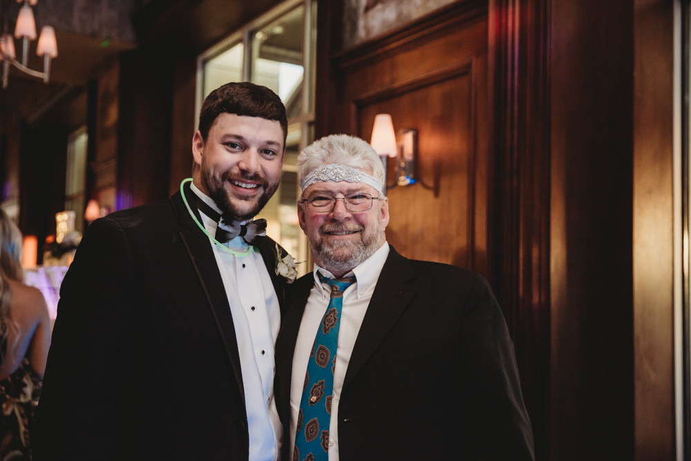 Wedding moment during ring exchange, captured by tracy rowell.