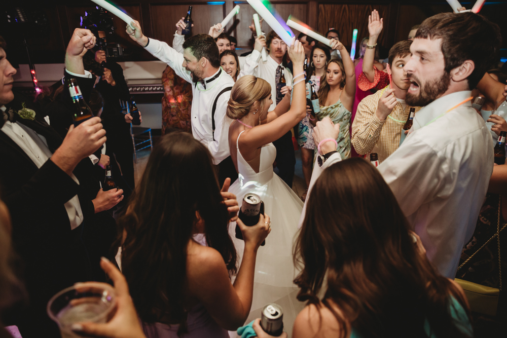 Wedding moment during bouquet toss, captured by wedding.