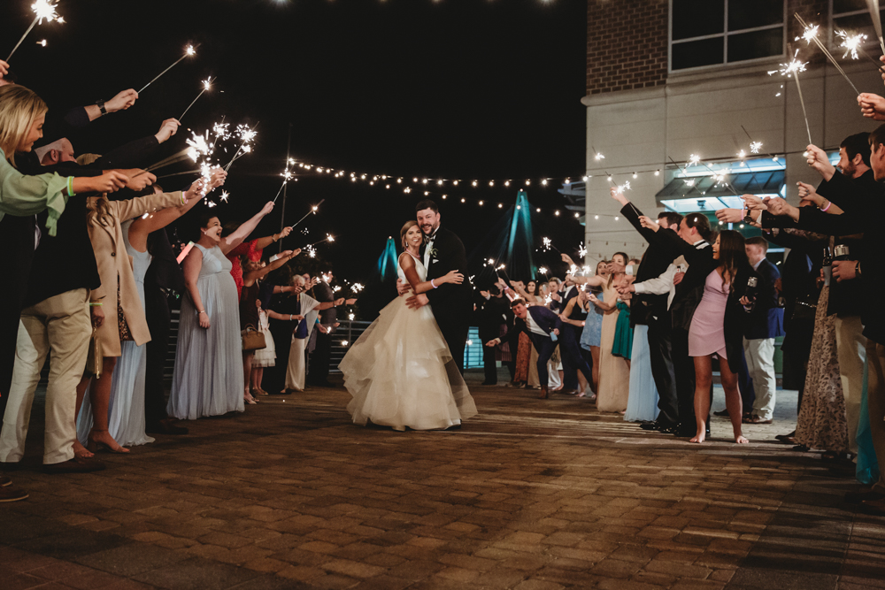 Wedding moment couple during sparkler exit, captured by tracy rowell.