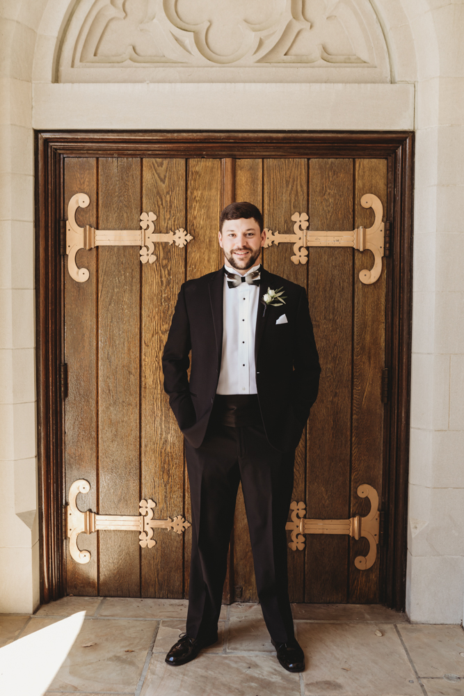 Wedding moment during groomsmen group shot, captured by reflection images by tracy rowell.