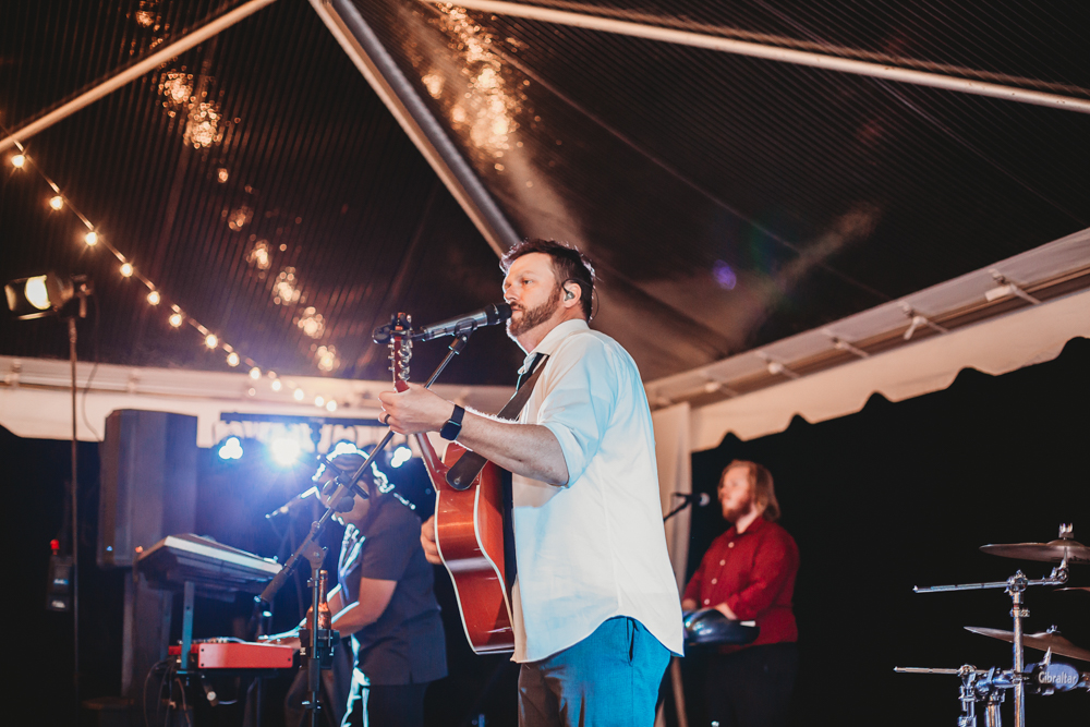 Jebb Mac Band performs live with guitar and keyboard under the tent at Wavering Place reception, captured by Reflection Images by Tracy Rowell in Florence SC.