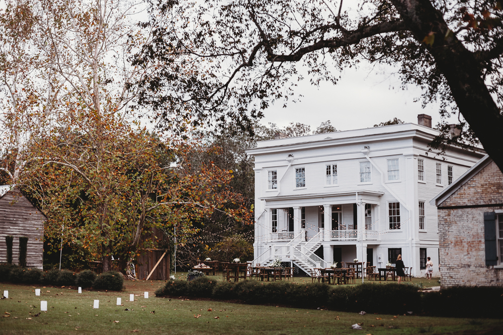 Grand white historic home at Wavering Place with fall foliage and lawn setup during Morgan and Daniel’s wedding in Eastover, South Carolina, Reflection Images by Tracy Rowell wedding photography