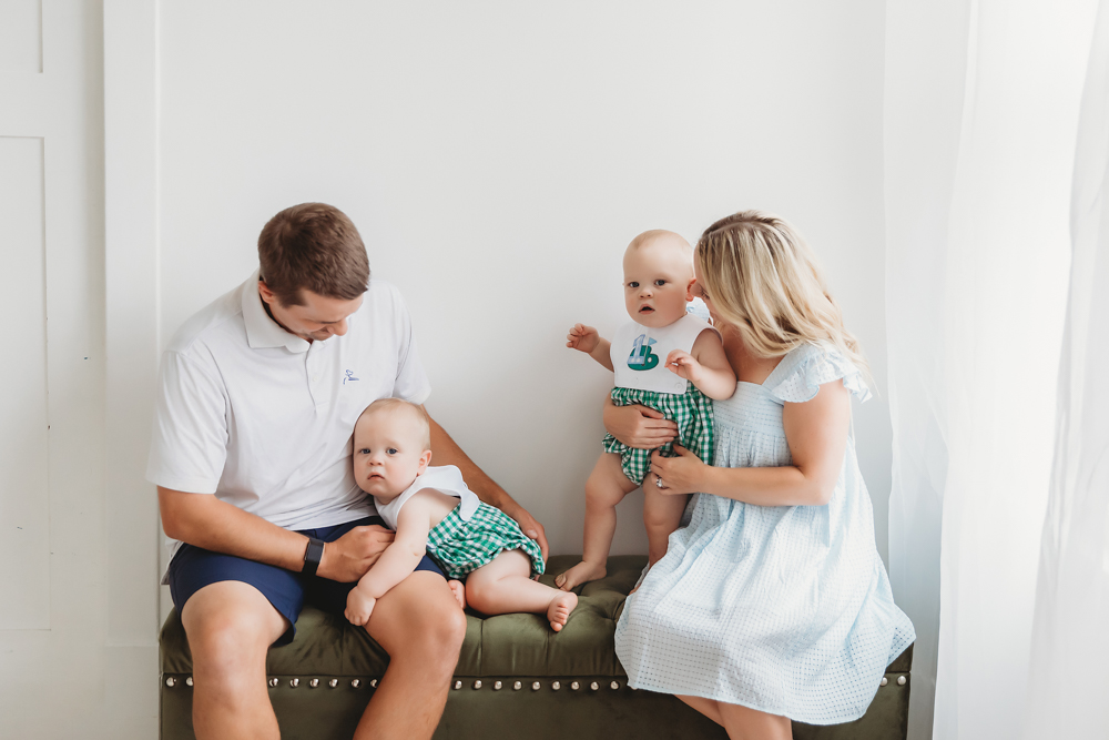 Twins with parents on green ottoman, natural light studio setup at Reflection Images by Tracy Rowell in Florence SC